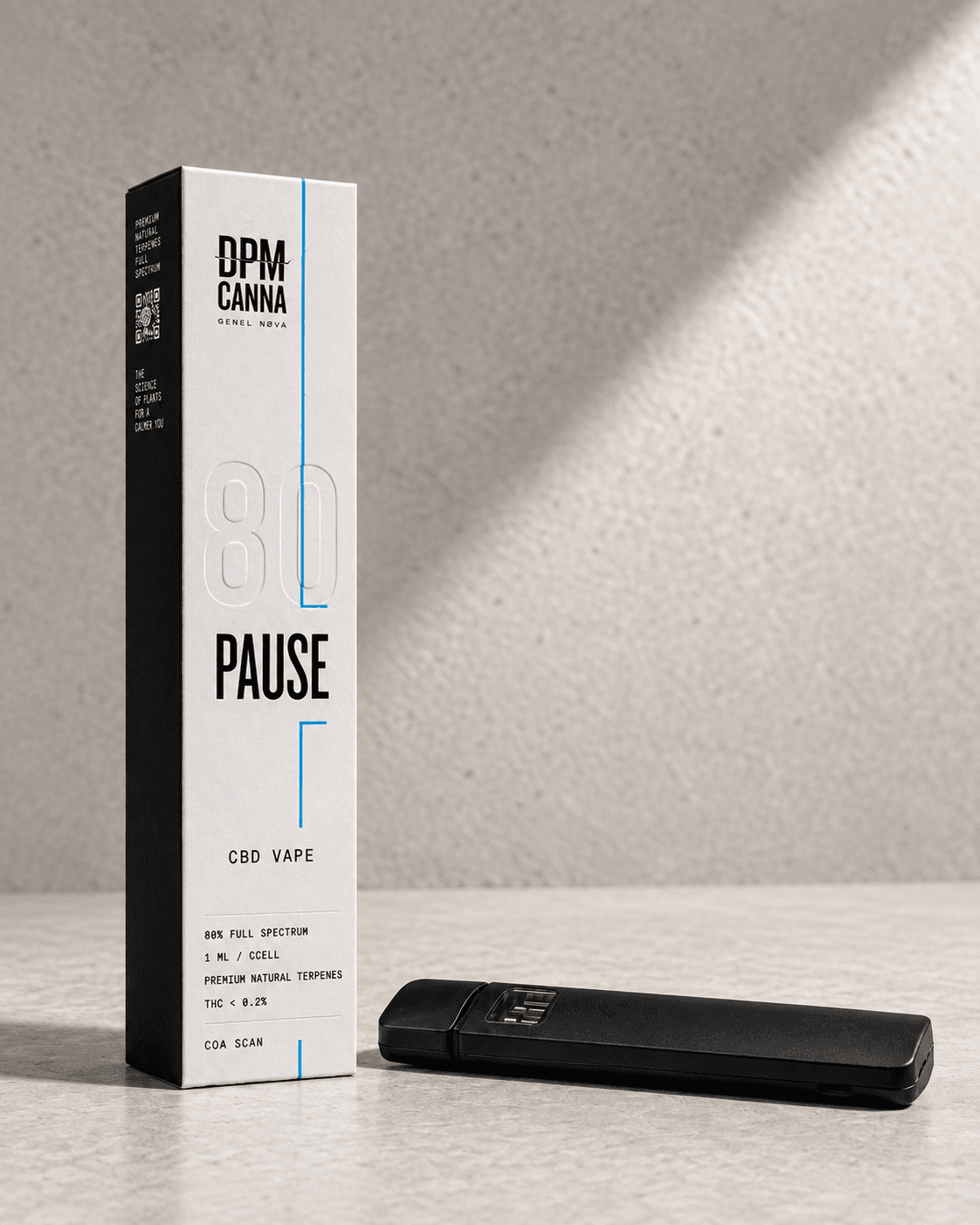 The slim black Pause vape lying beside its white box